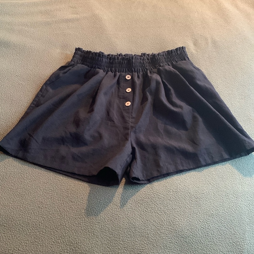 Nancy Kole black shorts with elastic waistband and button detail. Size Large